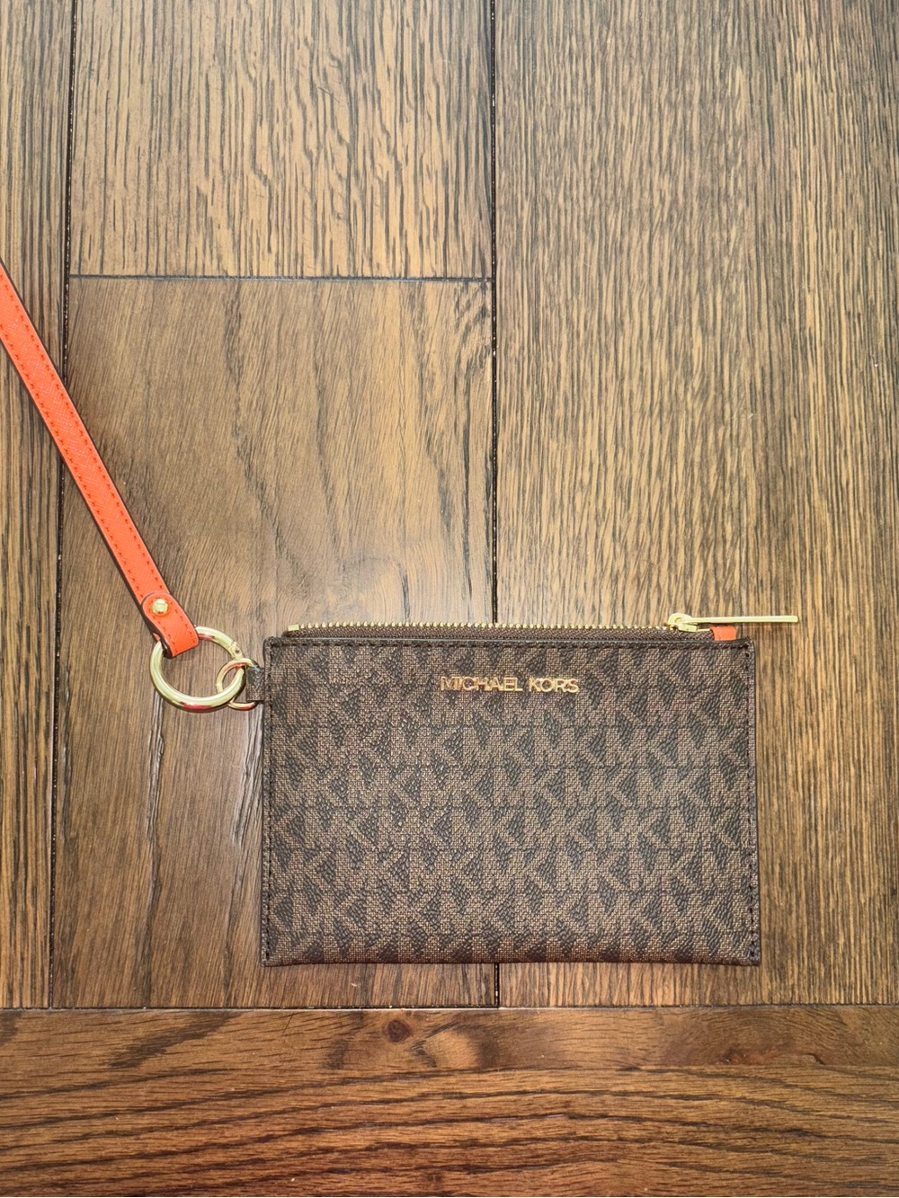 Michael Kors Brown Monogram Wristlet with Orange Trim